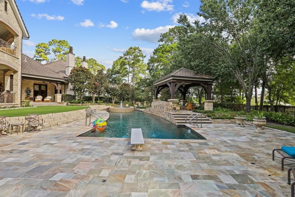 Tranquil oasis resort style pool and lush landscaping offer serenity in the woodlands texas asking for 5. 95 million 11